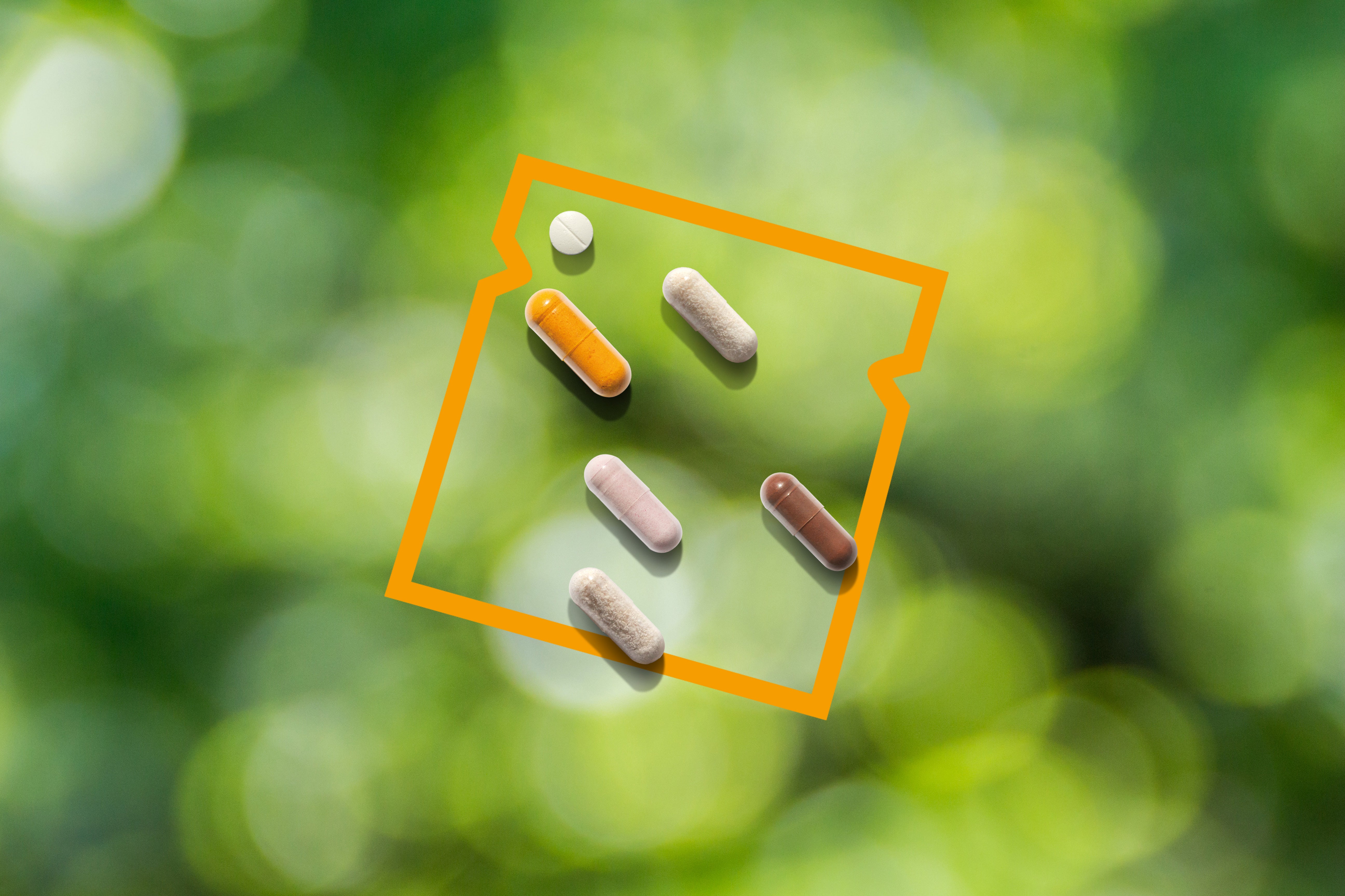 Generated picture of six different dunatura capsules with an orange vector graphic in the foreground and blurry green tree leaves in the background